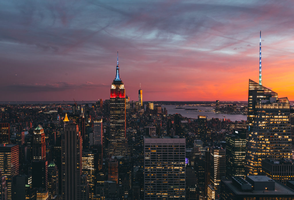 Vibrant sunset behind the New York City skyline viewed from Top of the Rock