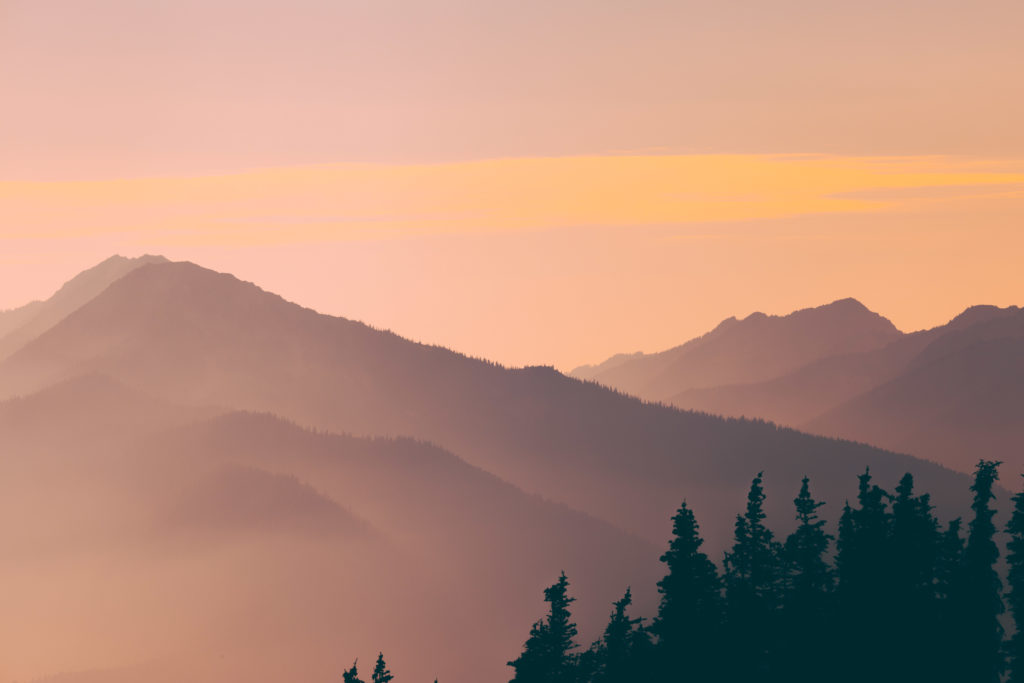 Layered mountain ridges fading into haze at sunset in Olympic National Park, Washington